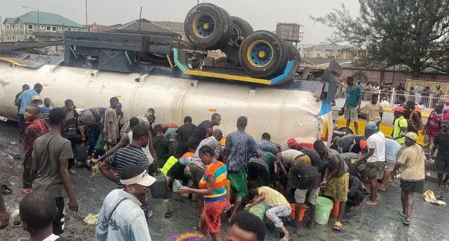 Lagos Residents Risk Lives to Scoop Fuel from Overturned Tanker!